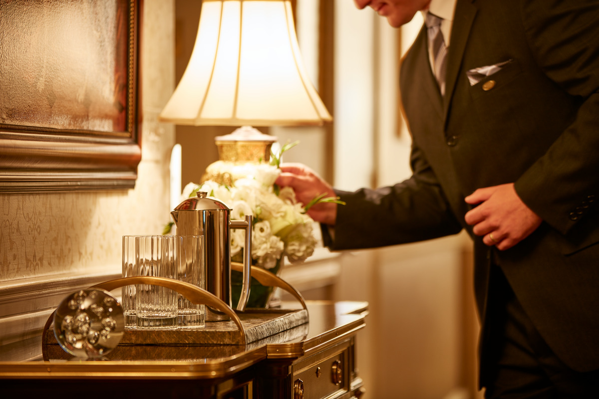 Associate arranging a vase of white flowers at Frank E Campbell Funeral Chapel.