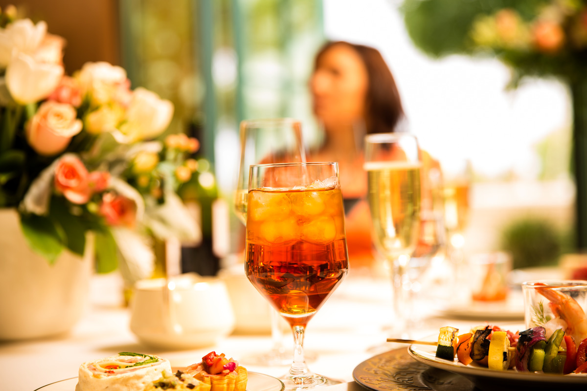 A life celebration featuring food and beverages with flowers on the table. 