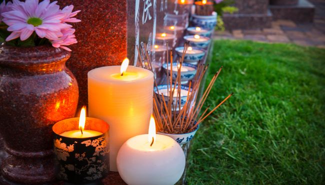Lit candles surround a monument at Palm cemetery in Las Vegas.