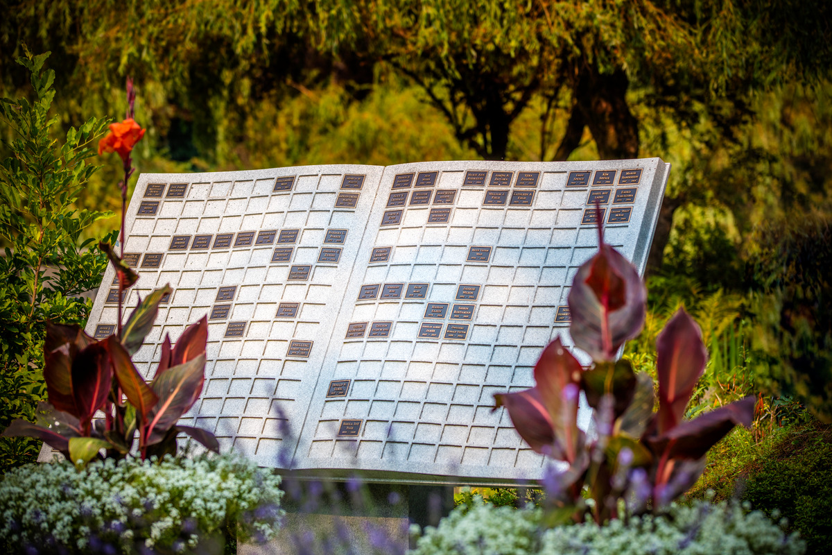 An carved stone ossuary, in the shape of a book, lists those laid to rest in a cremation garden at Boal Memorial Gardens.