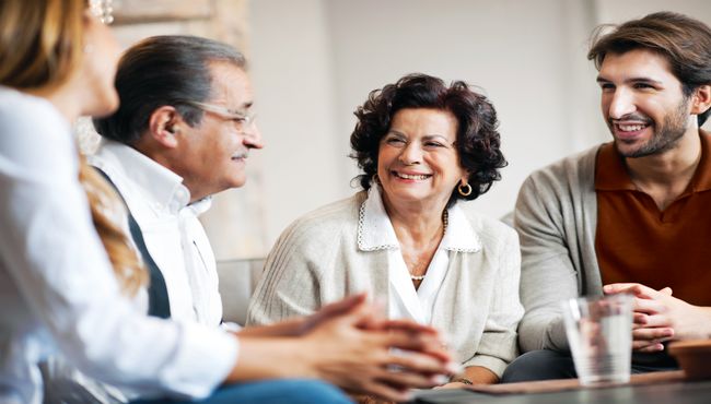 Parents and their adult children sit and talk
