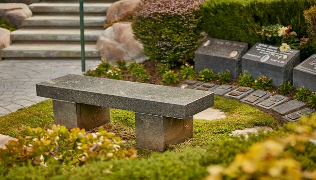 Memorial bench and markers in memorial garden at Pacific View