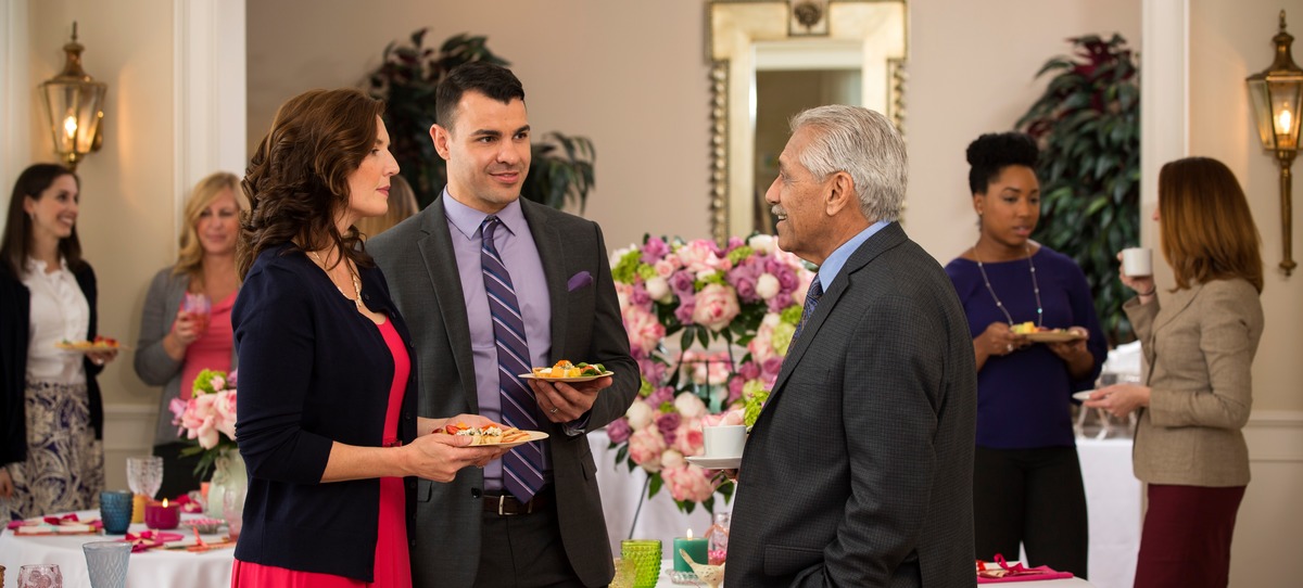 Guests at a memorial reception holding plates of food