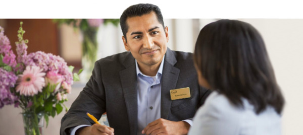A smiling associate helping a lady