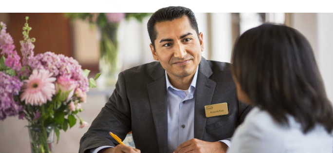 A smiling associate helping a lady