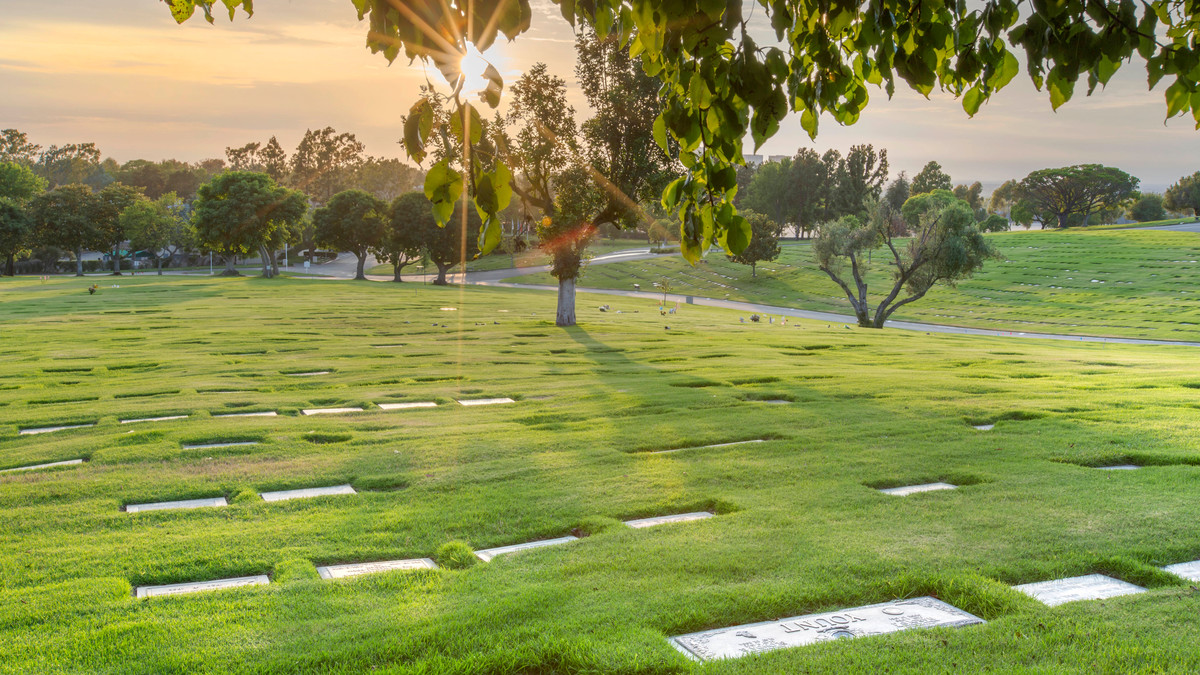 Community garden with a lawn crypt and bronze markers at Pacific View Memorial Park. 