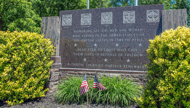 This granite monument dedicated to Veterans and their families reads 'Patriotic Sacrifice Forever Remembered' at Highland Park Cemetery & Mausoleum