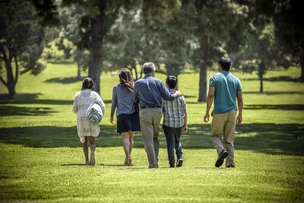 Family walks through the cemetery at Rose Hills.