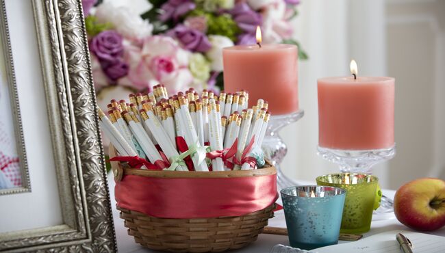 Personalized take-away pencils in a basket in a memorial display.