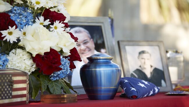 Cremation memorial for a U.S. Veteran with patriotic colors and photographs.