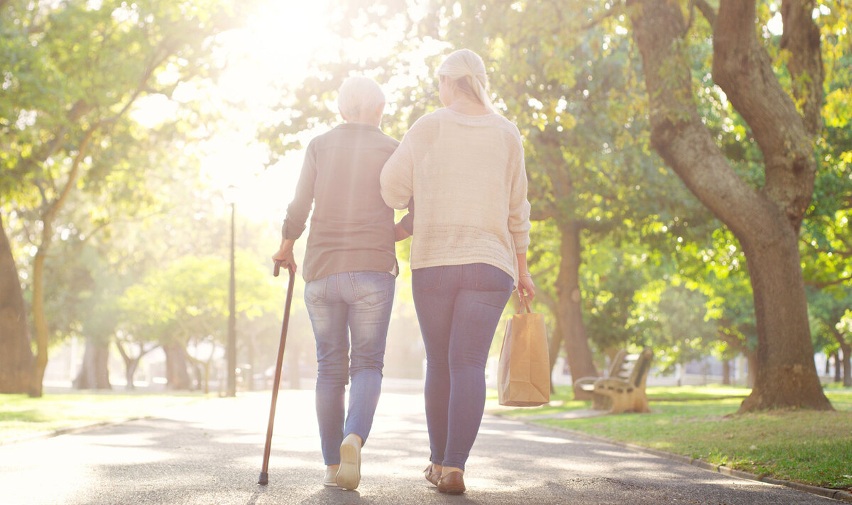 Mother and daughter walking in the park