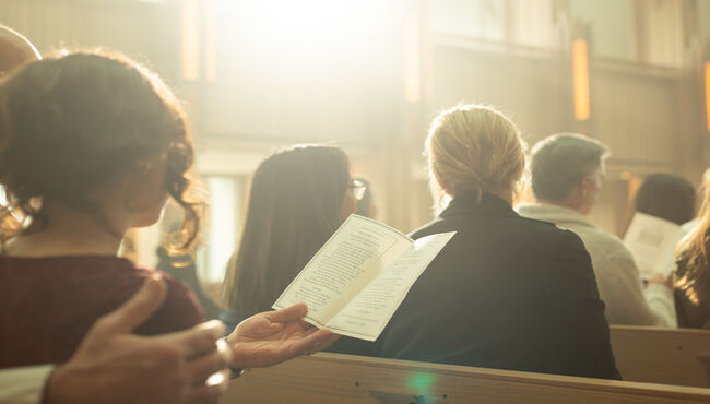people sitting in pews during church service