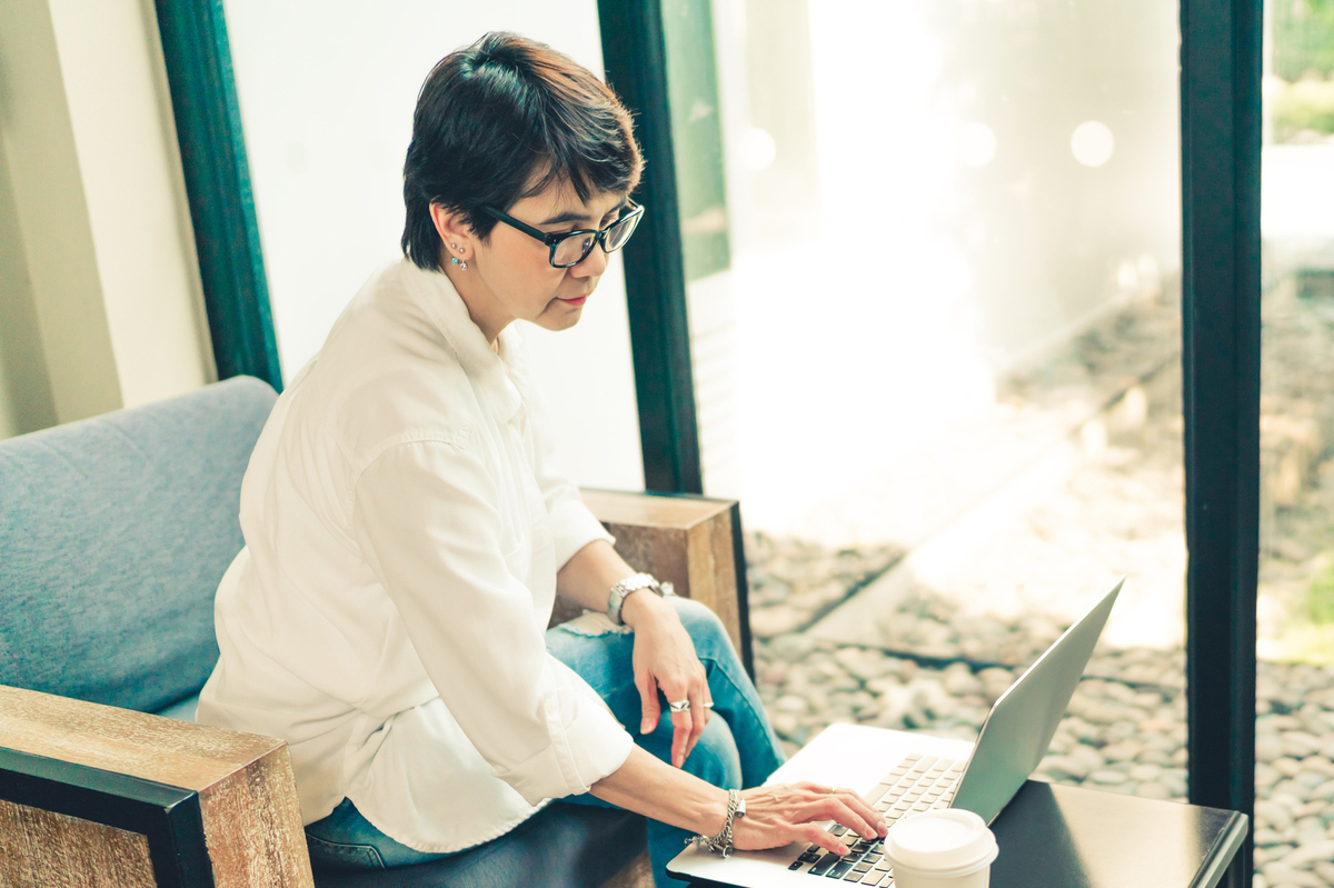 Asian mature woman using laptop 