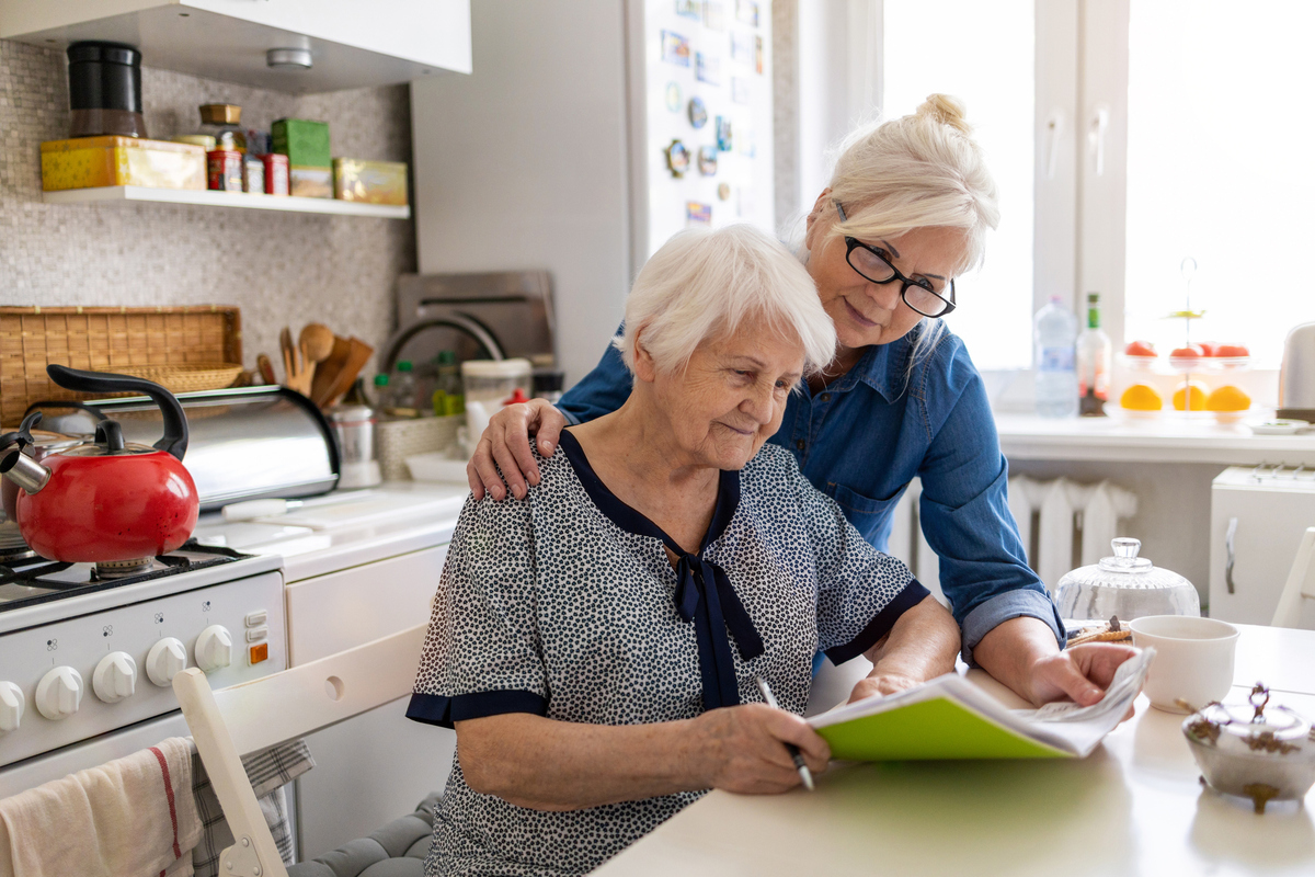 mother and adult son hugging in kitchen