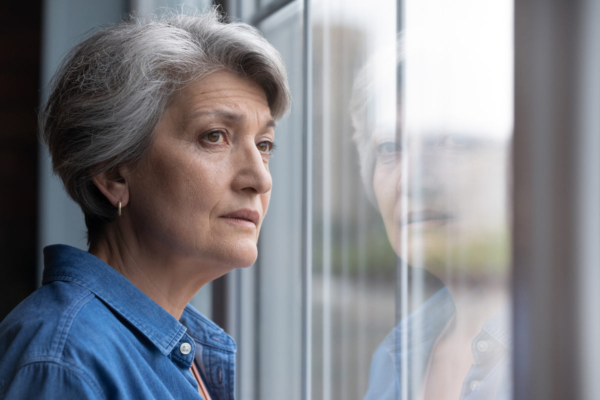 woman looking out window